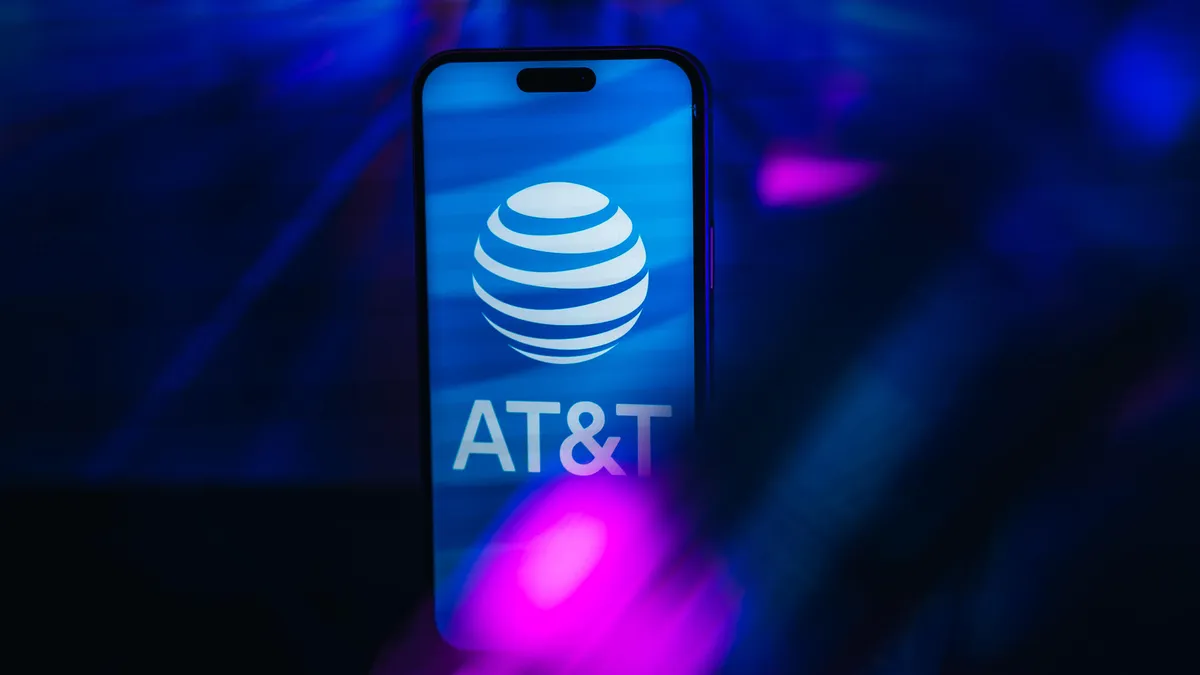 AT&T logo on iPhone screen against a blue backdrop
